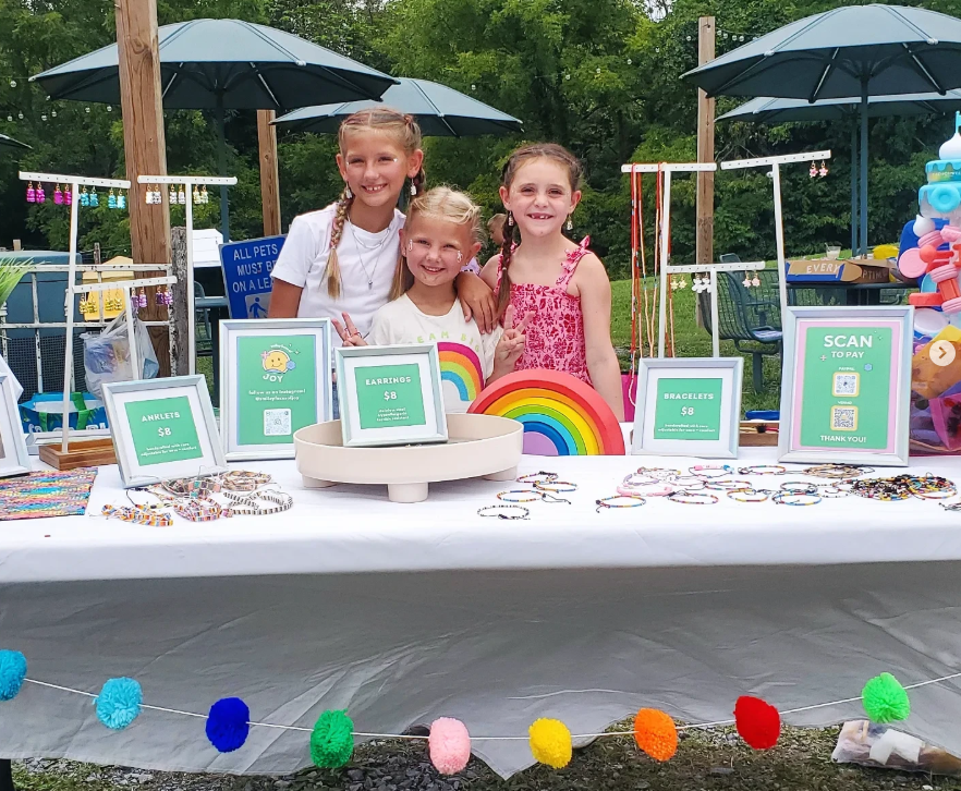 The three founders at their market stand